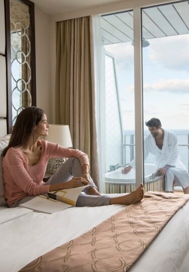 Couple relaxing inside stateroom on a cruise