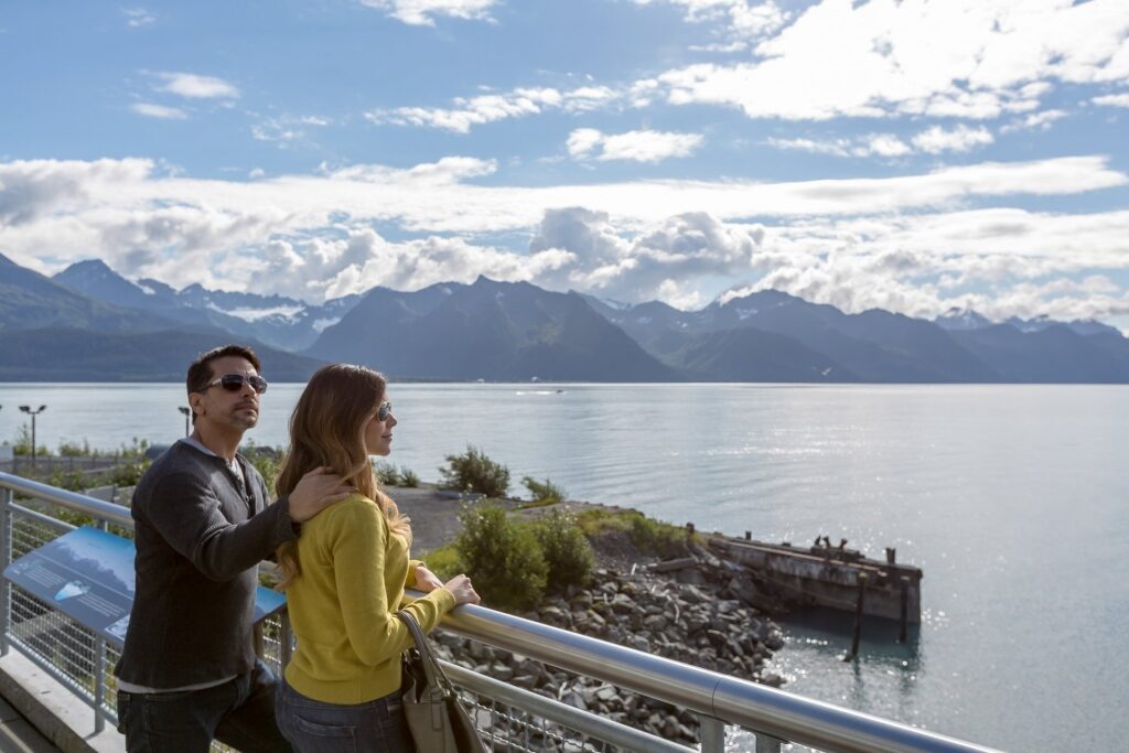 Couple standing by the railing in Alaska
