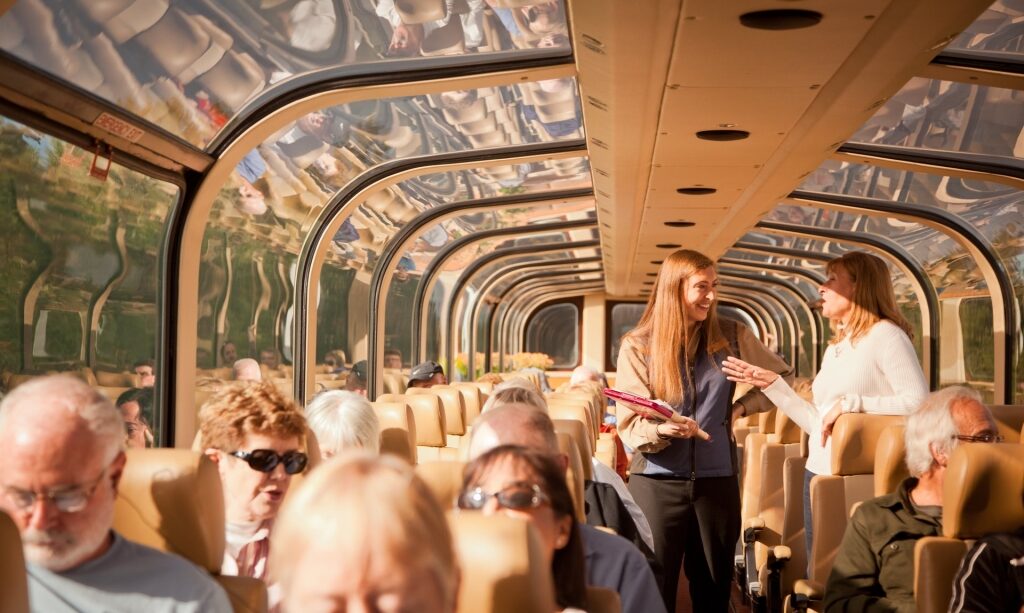 People inside a glass-domed train