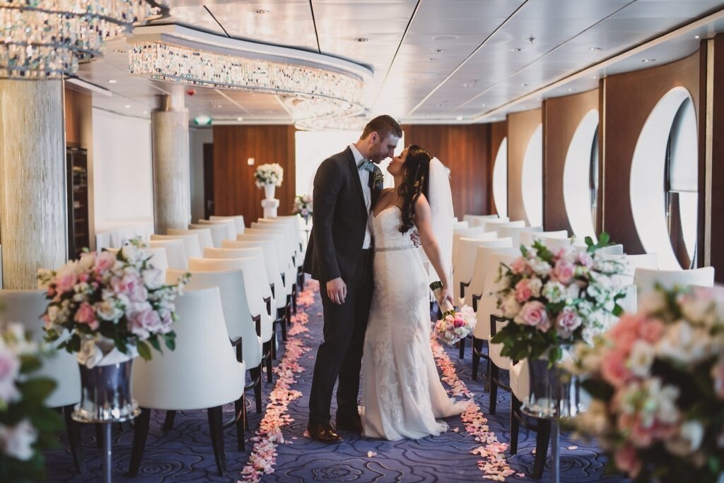 Couple kissing on the aisle of Celebrity wedding venue