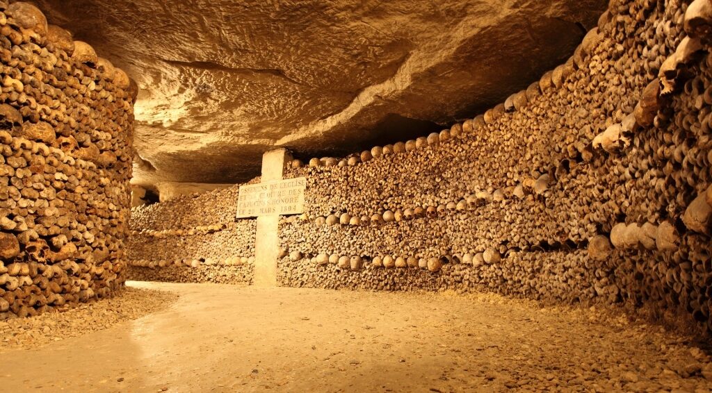 Eerie wall of skulls and bones in Paris Catacombs