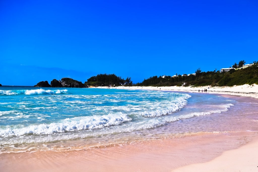 Small waves and pinkish shore of Horse Shoe Bay