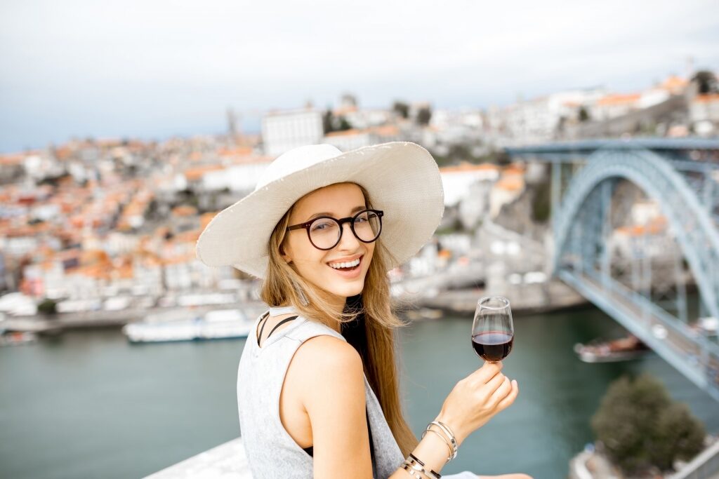 Woman drinking wine in Porto