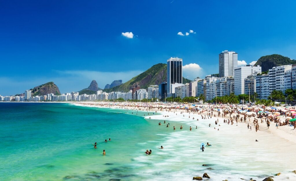 People enjoying the pristine beach of Copacabana