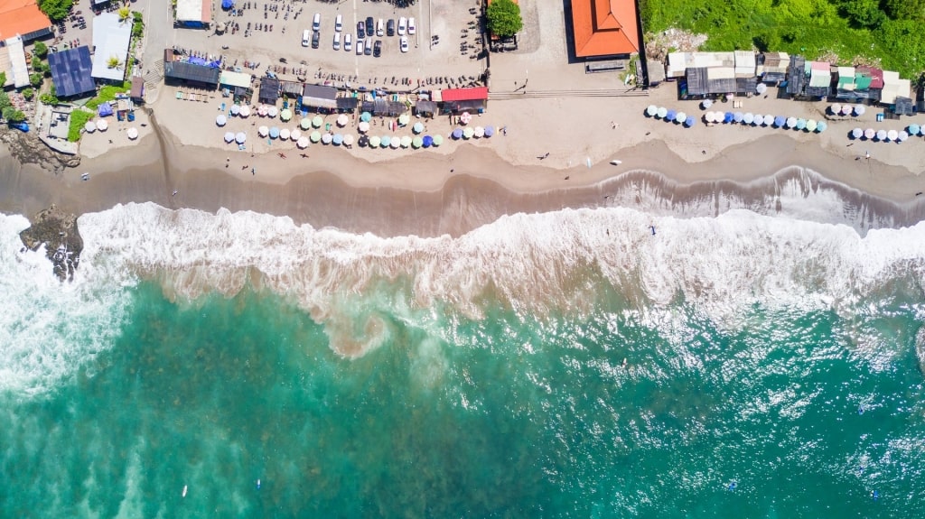 Aerial view of Canggu Beach with large waves approaching the shore