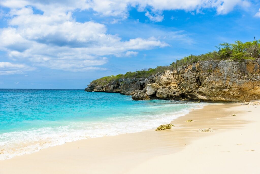 White sands and turquoise waters with cliffs of Knip Beach, Curacao