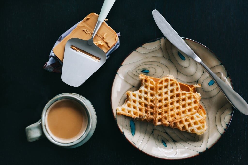 Heart-shaped waffles alongside Brunost and coffee