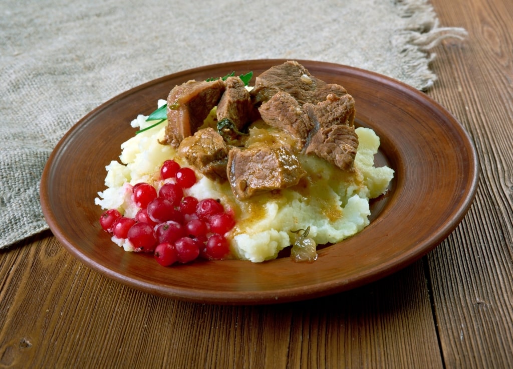 Norwegian food Finnbiff served on top of mashed potato with lingonberries on the side