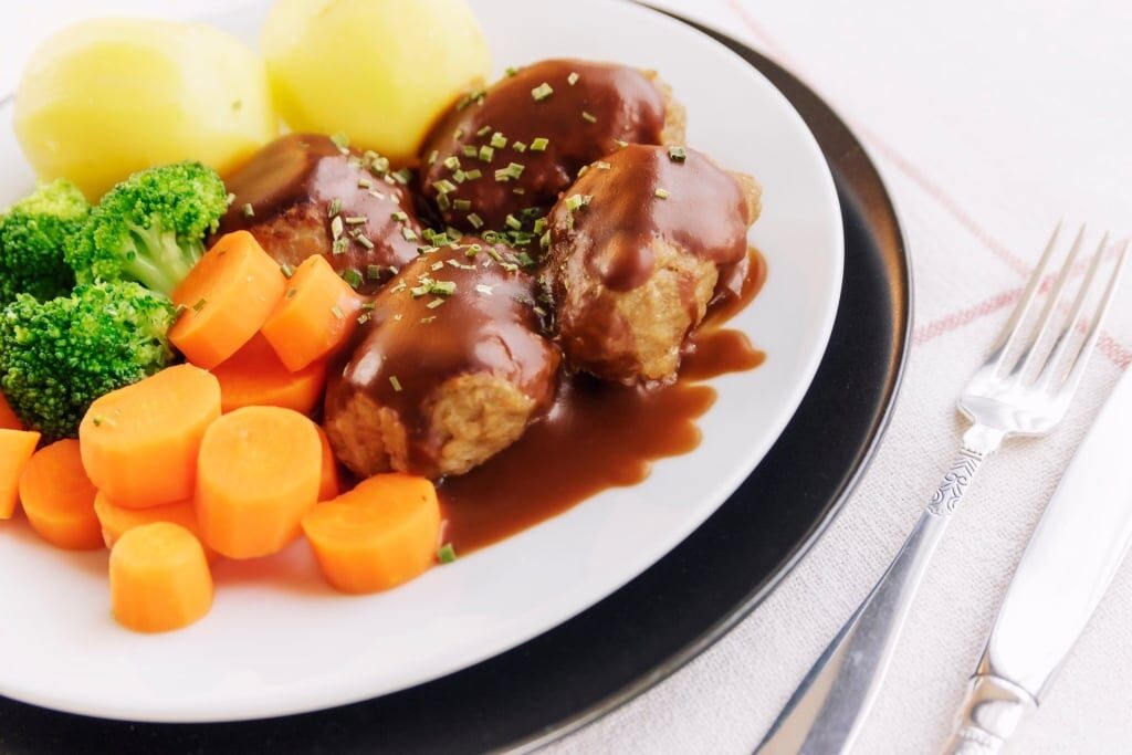 Norwegian food kjøttboller on plate served with carrots and potatoes