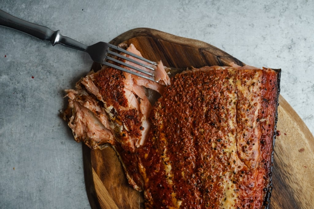 Meaty smoked salmon on a wooden board