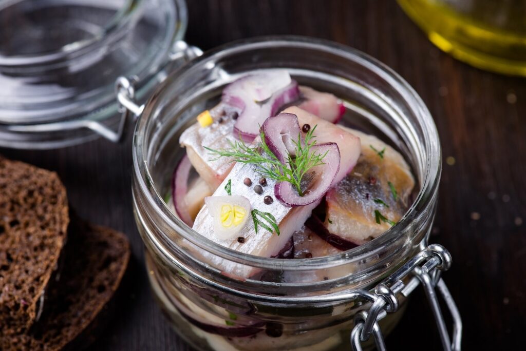 Pickled herring on a glass