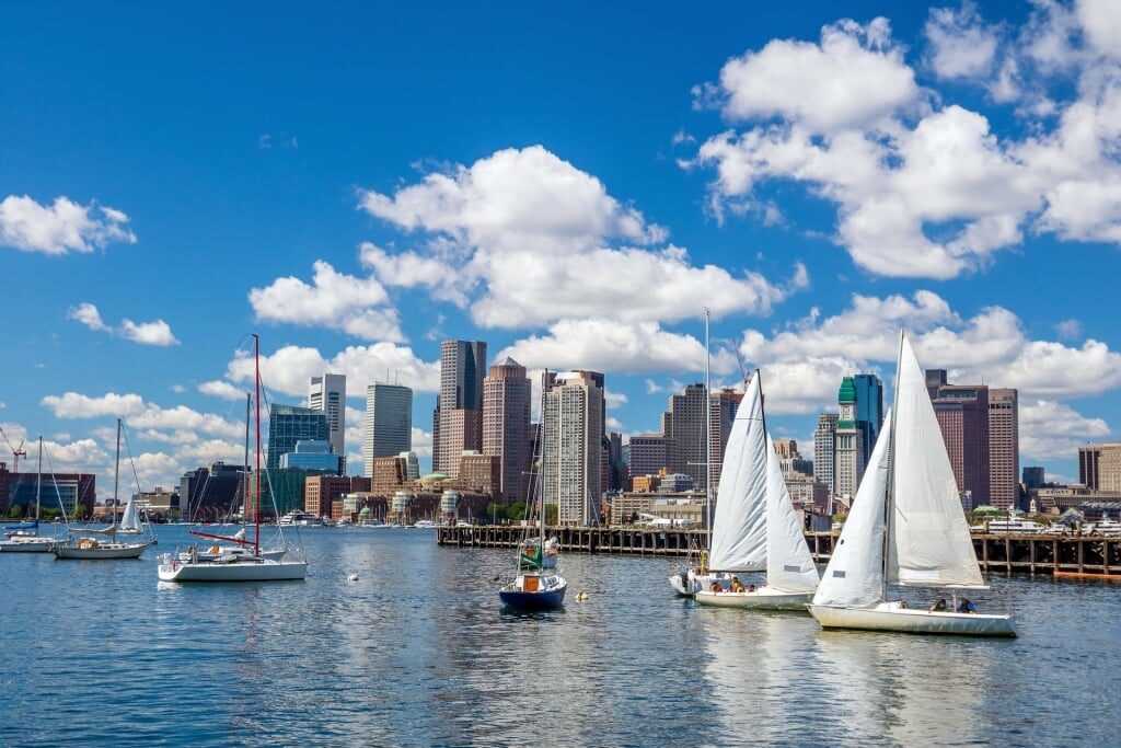 Catamarans in Boston Harbor with city skyline
