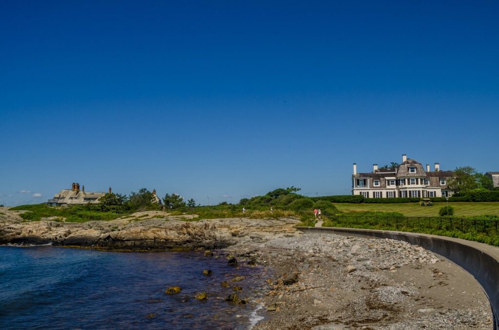 Scenic coastline of Newport Cliff Walk with mansion