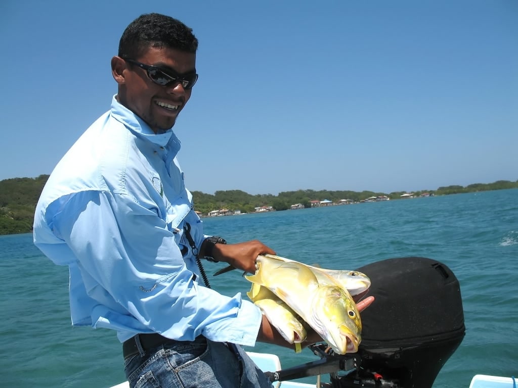 Guide with freshly-caught fishes in Roatan