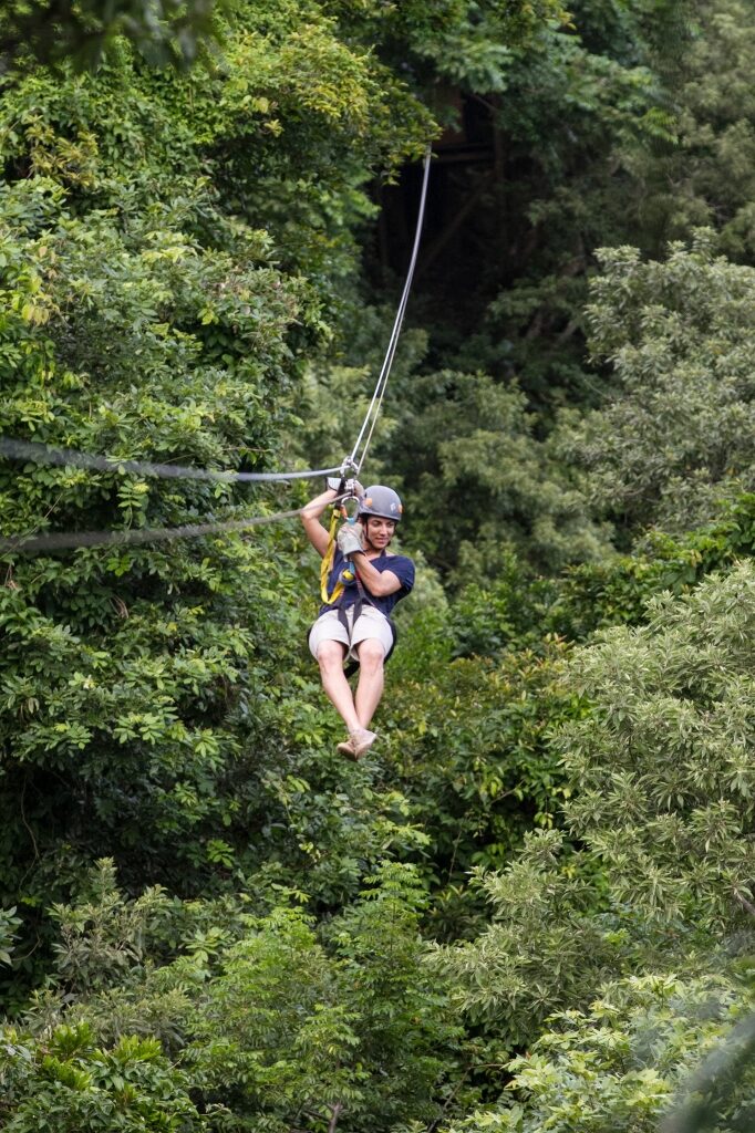 Man zip-lining at a rainforest in Roatan