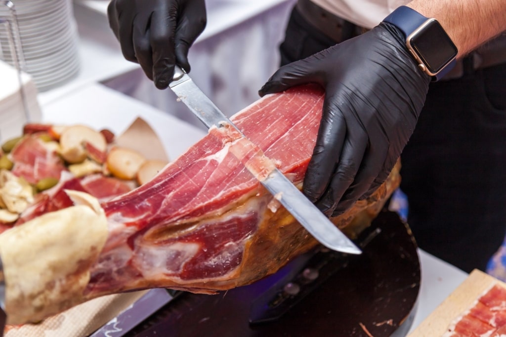 Chef slicing jamon