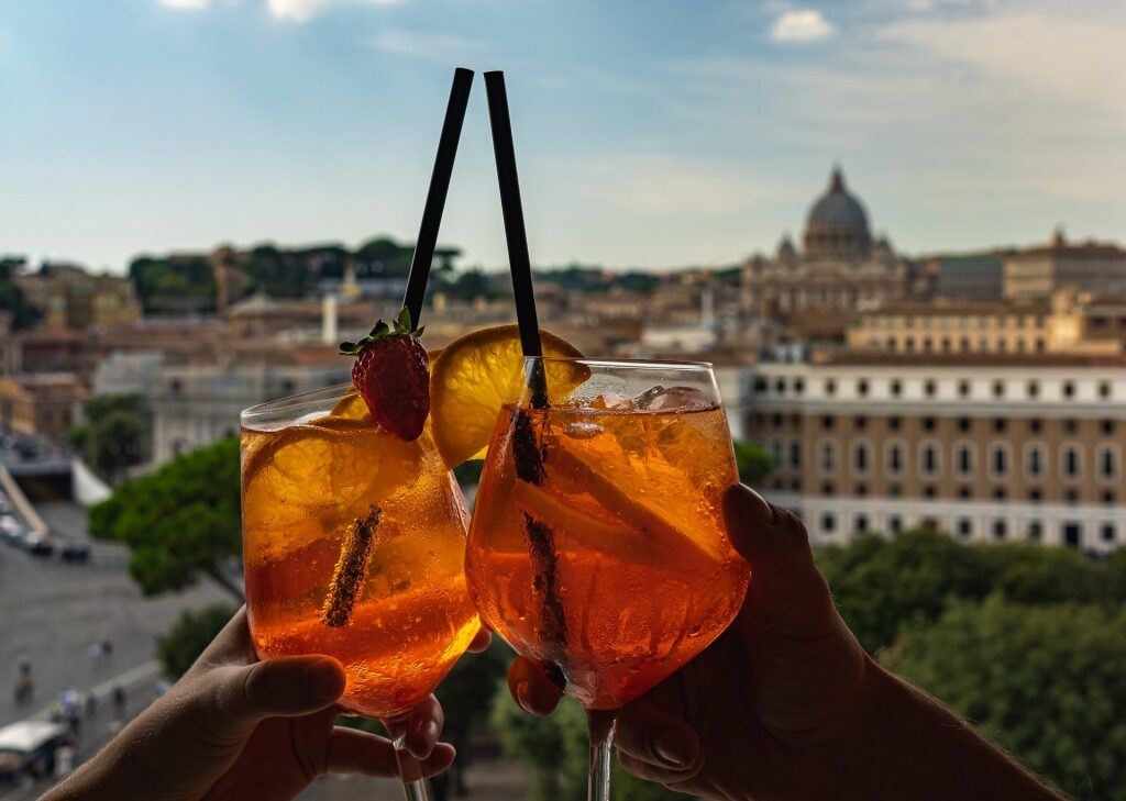 Couple drinking Aperol Spritz with view of Vatican