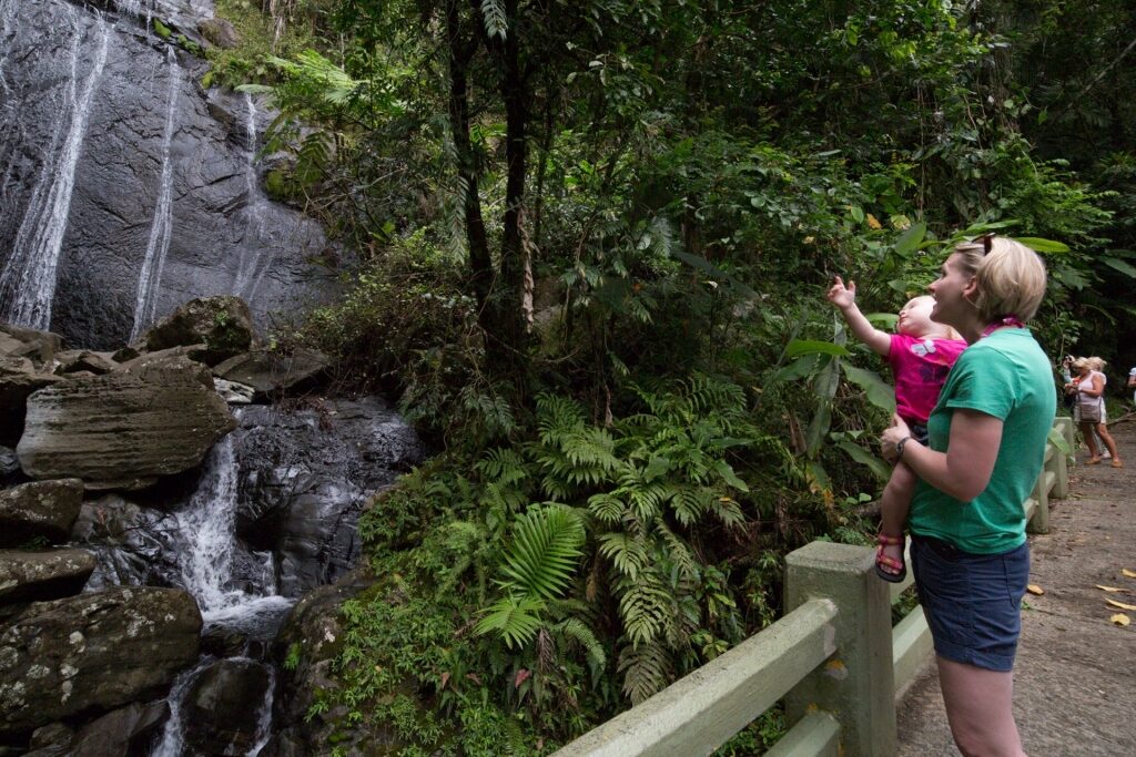 Tourists watching the Coca Falls in El Yunque National Forest