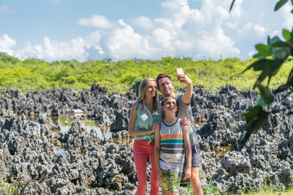 Family taking a photo from Hell, Grand Cayman