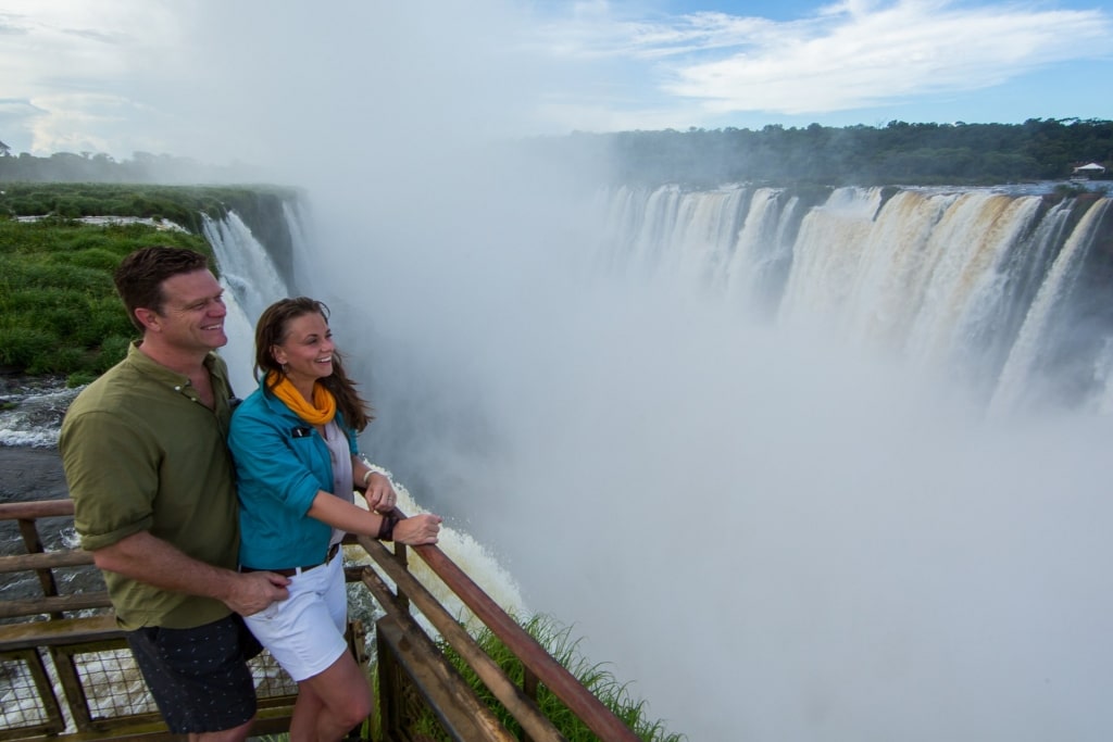 Couple looking at majestic Iguazu Falls