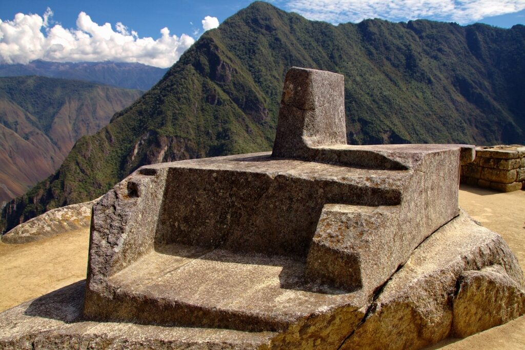 Sacred stone of Intihuatana overlooking the mountain
