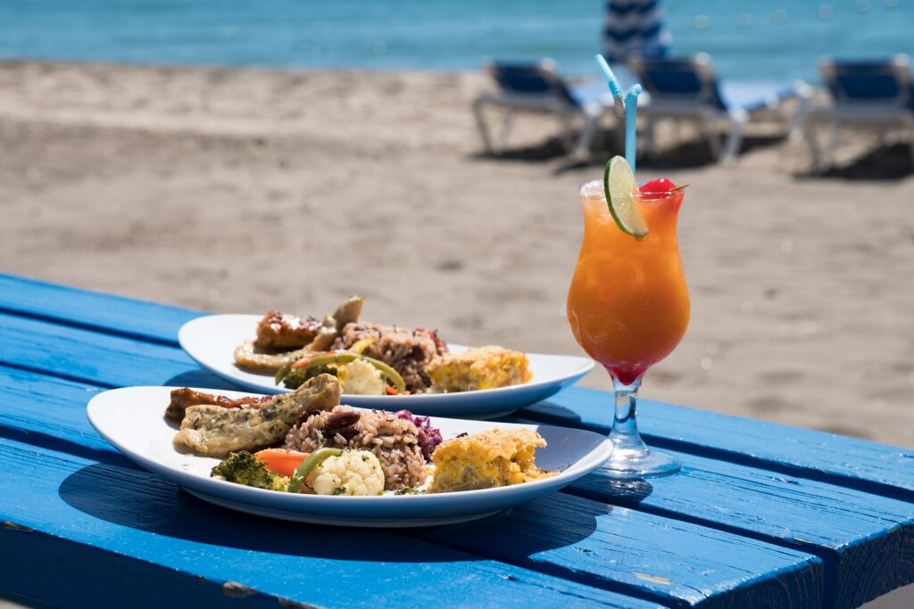 Cocktail and food served at a beach-side restaurant in St. Kitts