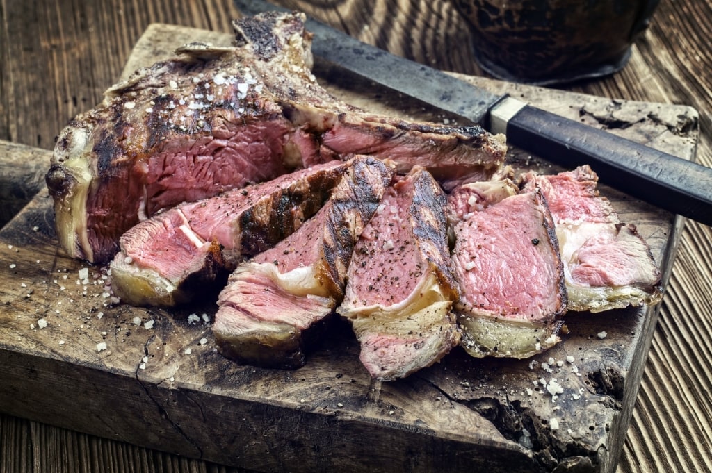 Sliced Bistecca alla Fiorentina served on wood