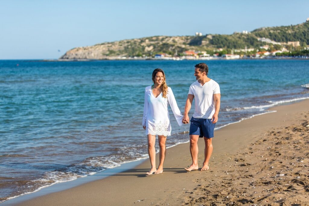 Couple walking at a beach in Rhodes