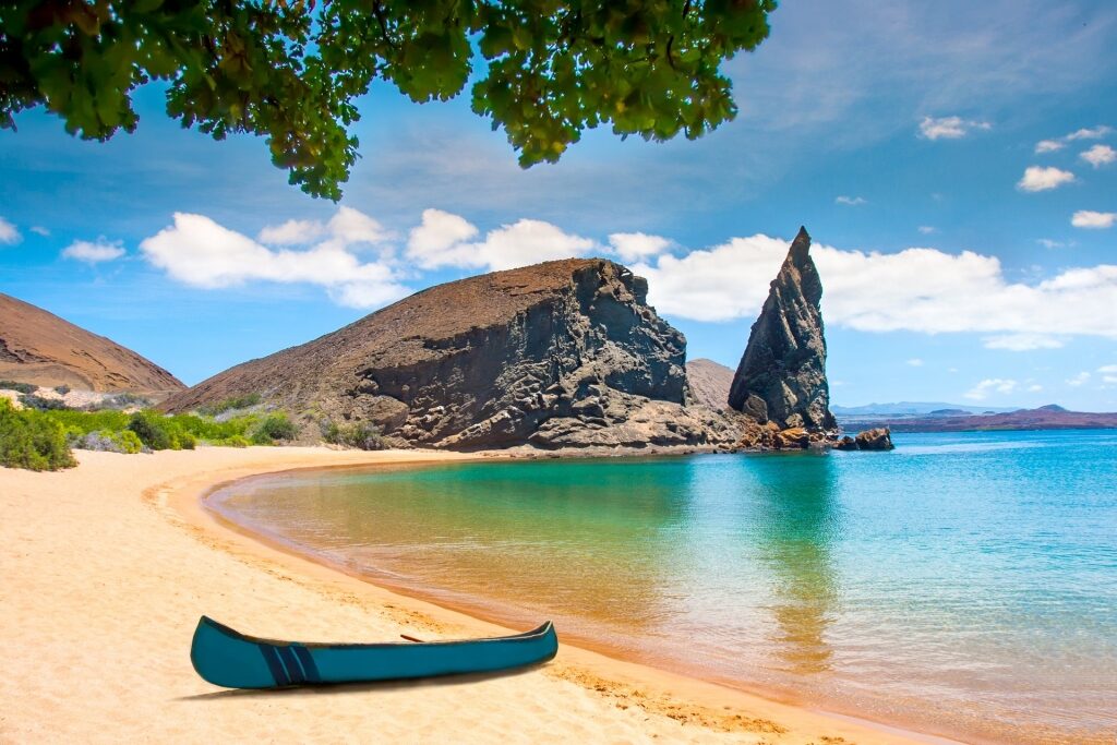 View of popular rock formation Pinnacle Rock from the beach