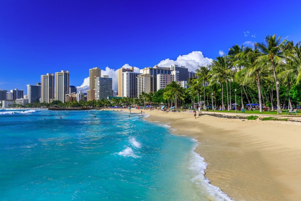 Beautiful Waikiki beach with buildings and palm trees