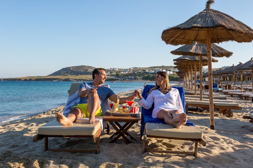 Couple relaxing on a beach in Mykonos