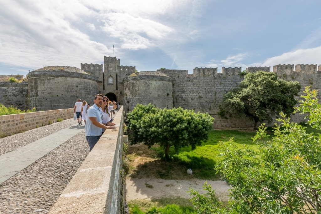 Couple sightseeing with view of Palace of the Grand Masters