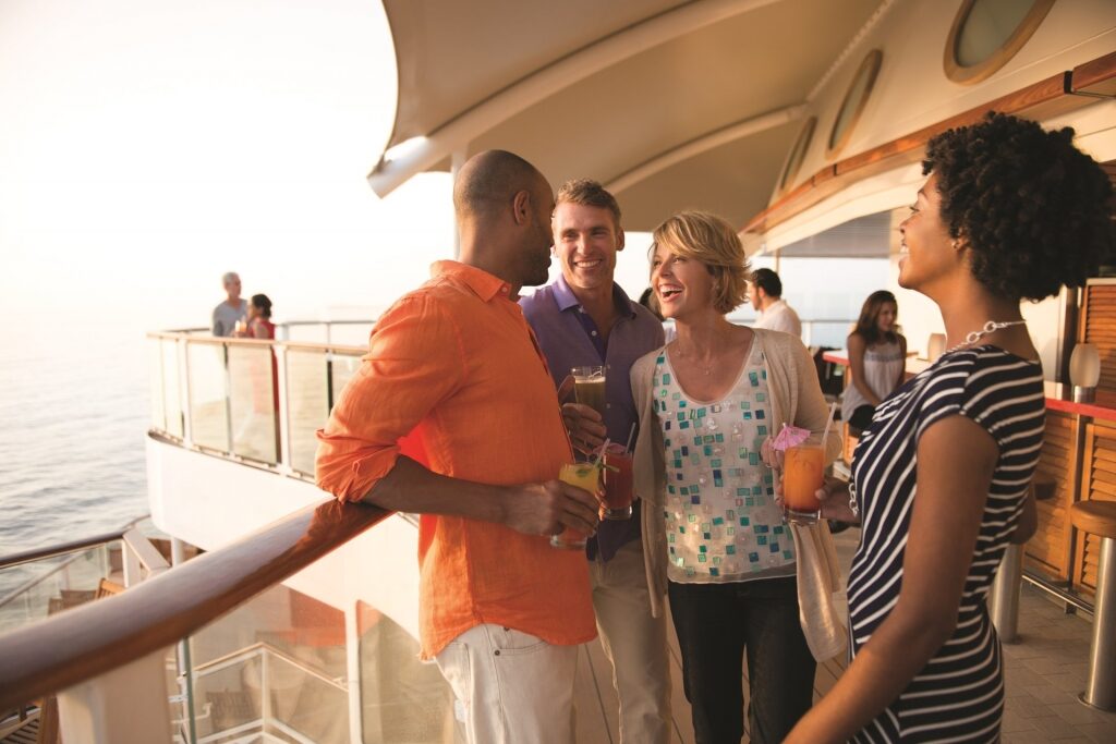 People hanging out over drinks on a cruise