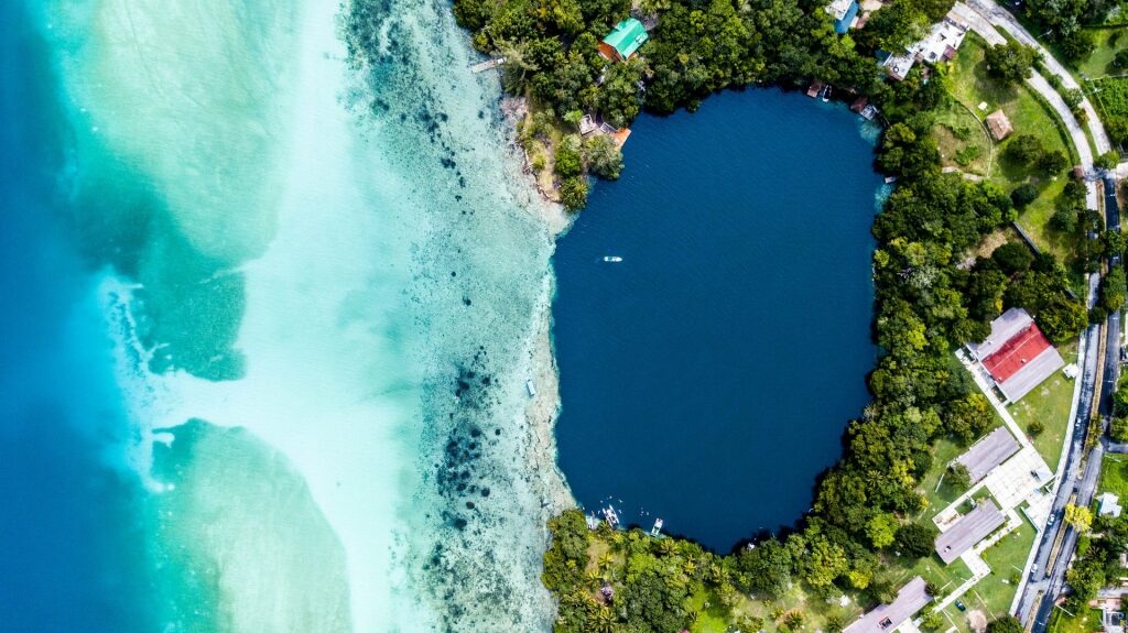 Aerial view of Bacalar Lagoon with different shades of blues and teals