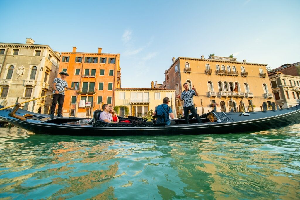 Couple on a romantic gondola ride in Venice, Italy in the summer
