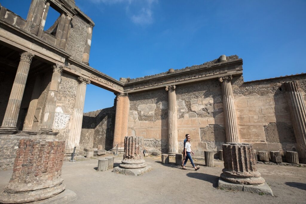 Couple exploring the historical site of Pompeii