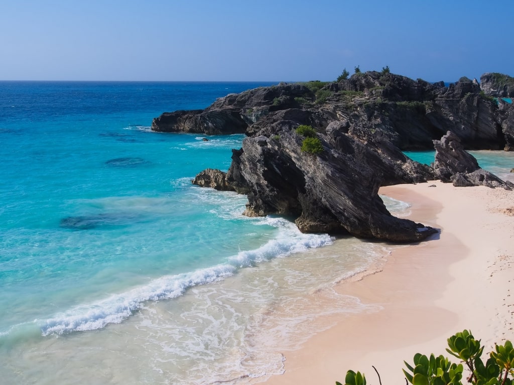 Rock formation and pinkish sands of Butts Beach