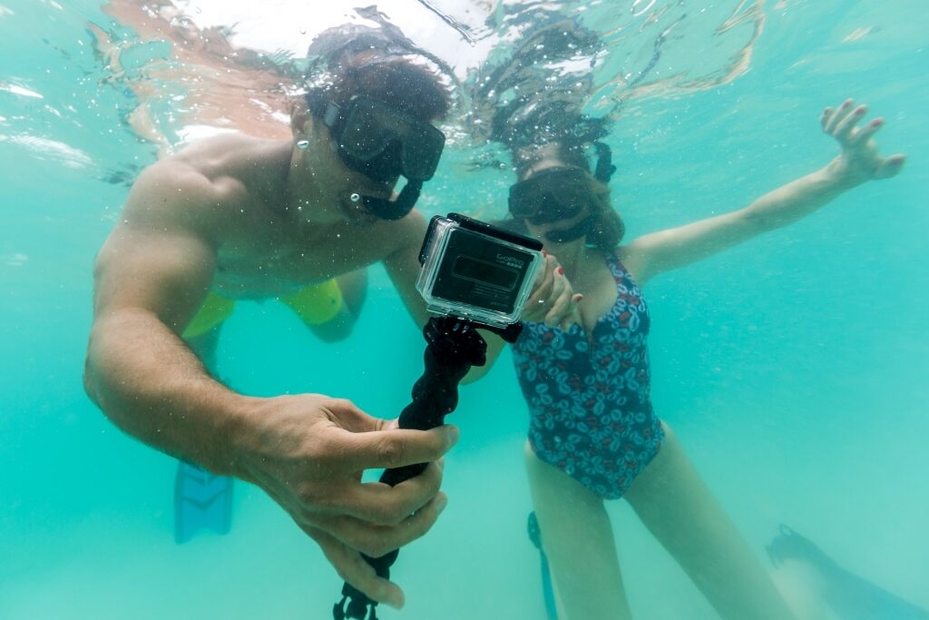 Couple snorkeling with GoPro camera