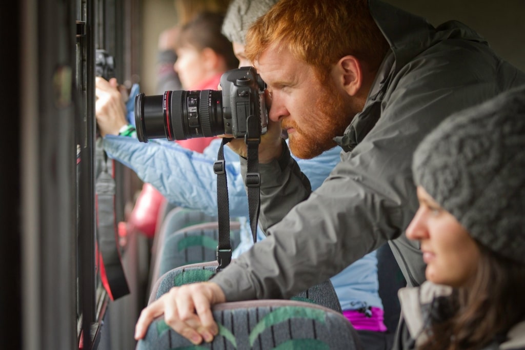 Photographer with camera while on an Alaska whale watching cruise excursion