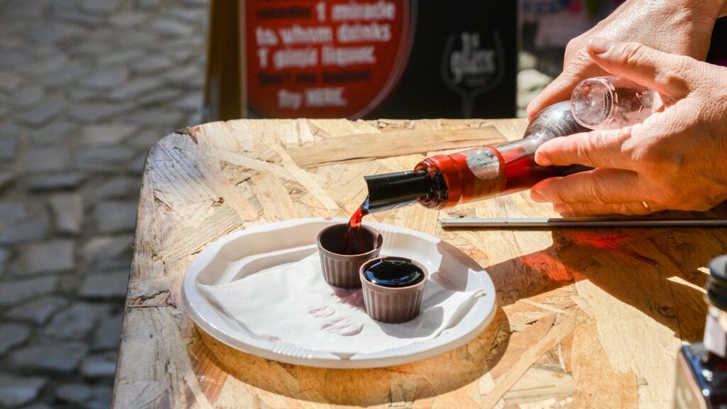 Man pouring traditional drink Ginja