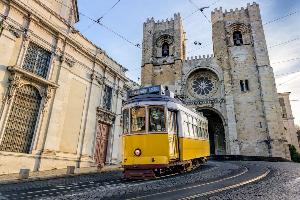 Popular yellow Tram 28 passing by cathedral