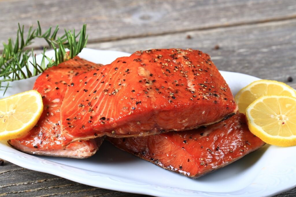 Plate of smoked salmon with lemon on the side