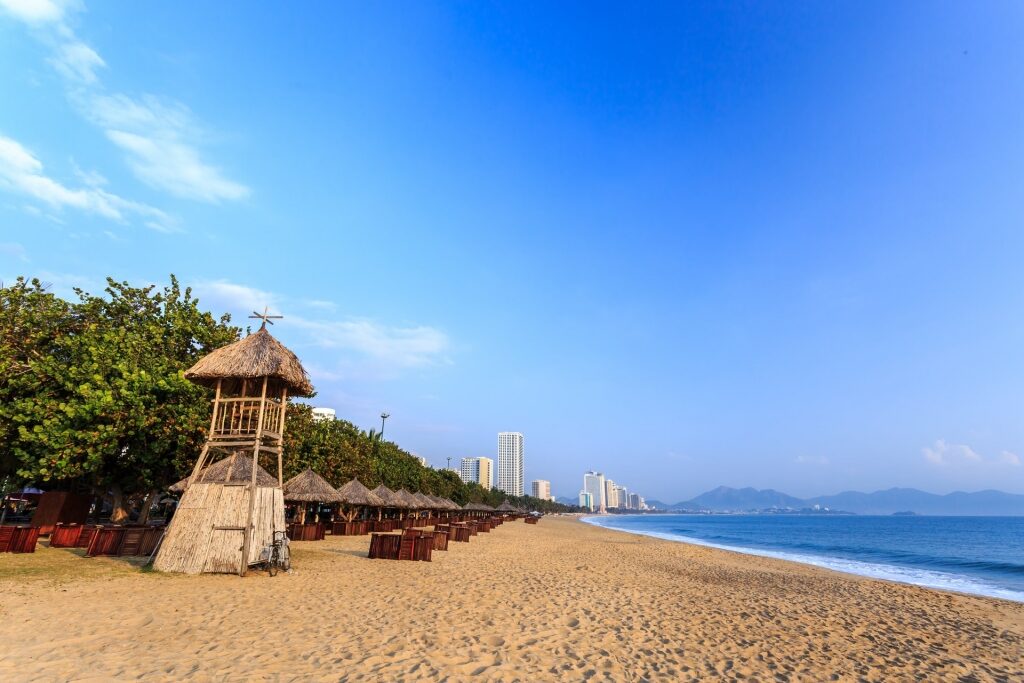 Beautiful sands of Nha Trang Beach with huts lined up