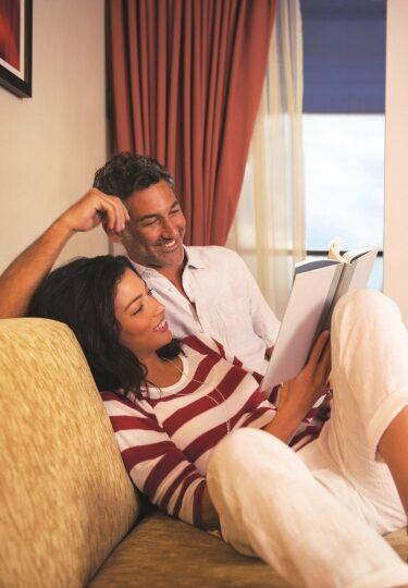 Couple relaxing inside stateroom