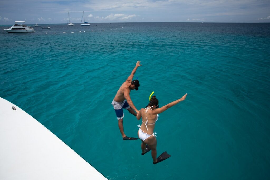 Couple jumping to the water