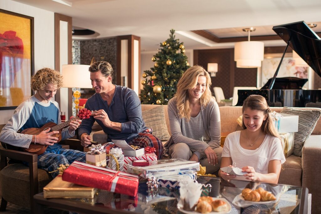 Family opening gifts inside cruise stateroom