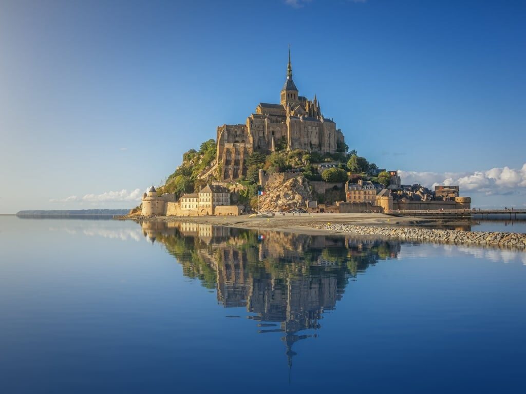 Landscape of Mont-Saint-Michel Abbey reflecting on water