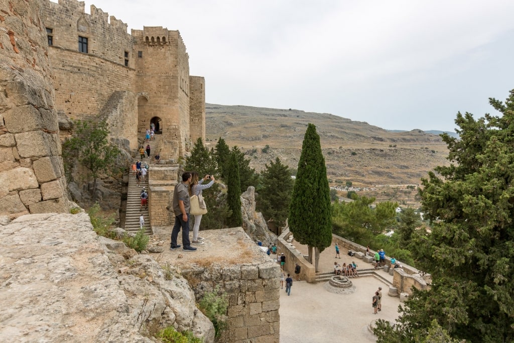 Couple enjoying the picturesque view of Acropolis of Lindos