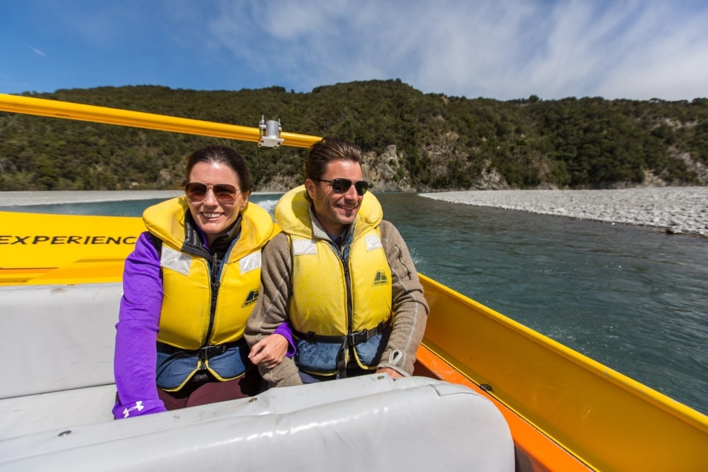 Couple on an alpine jet boat in Christchurch, New Zealand