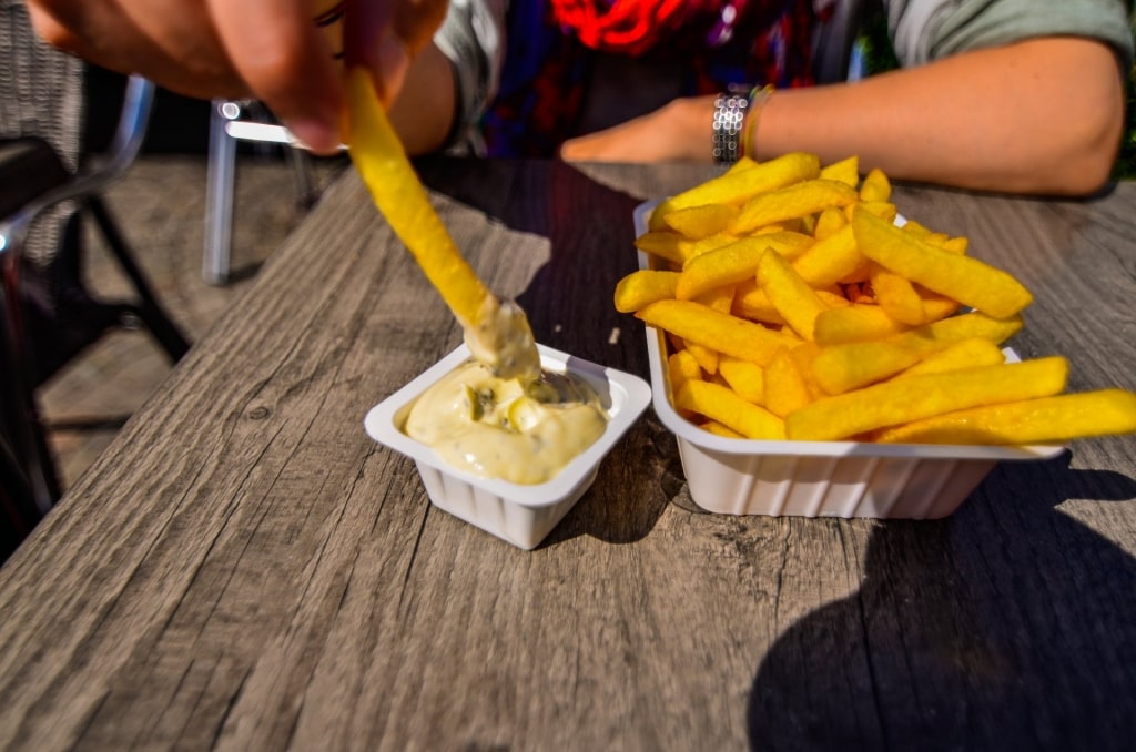 Man eating Belgian fries 